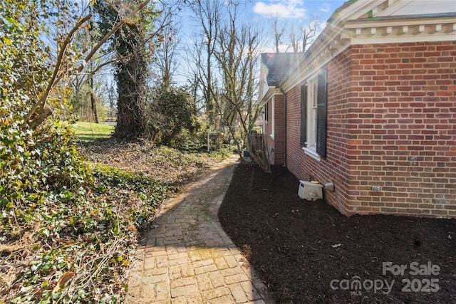 view of property exterior with brick siding