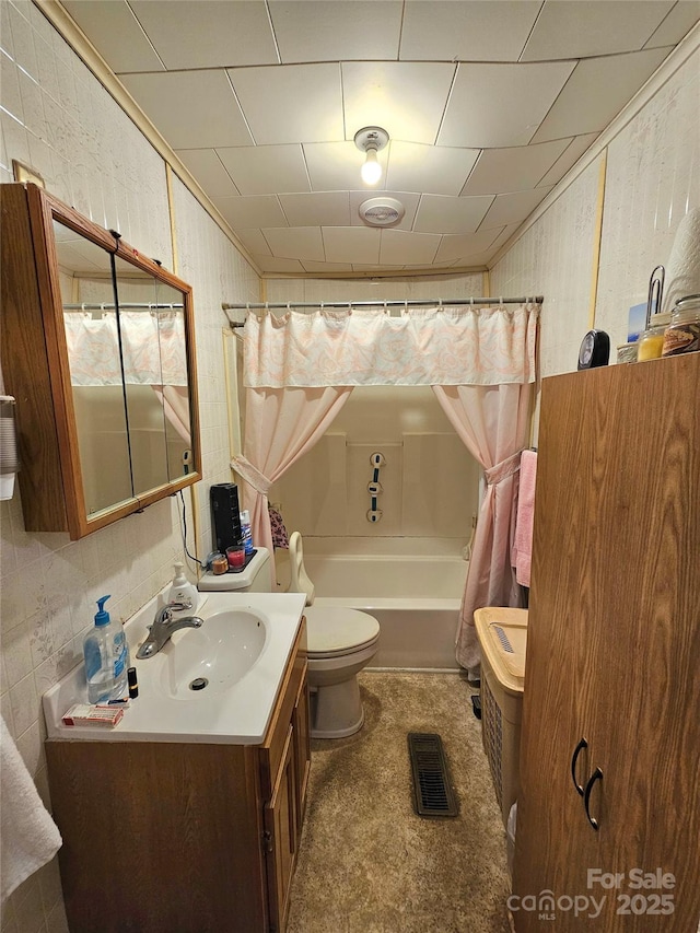 full bathroom featuring visible vents, toilet, vanity, crown molding, and shower / bath combination with curtain