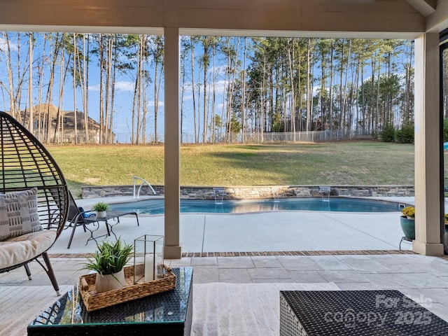 outdoor pool with a fenced backyard, a lawn, and a patio