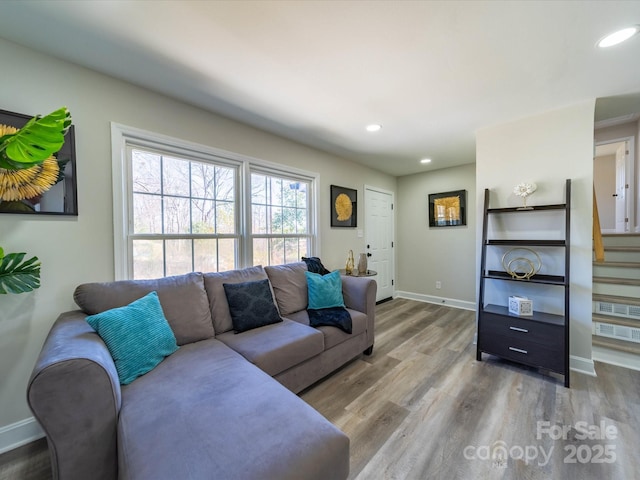 living area featuring recessed lighting, stairway, baseboards, and wood finished floors