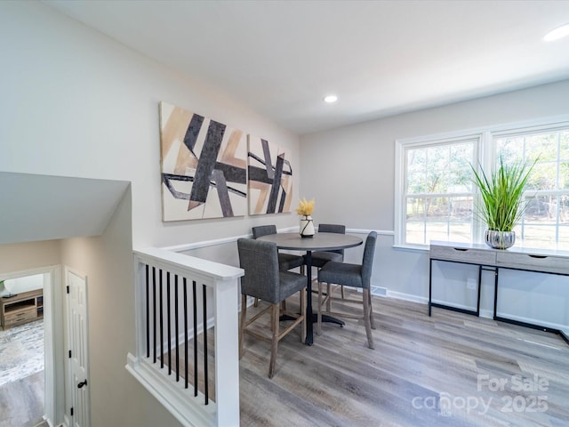 dining area featuring light wood-style floors, baseboards, and recessed lighting