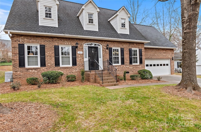 new england style home with a garage, brick siding, a shingled roof, concrete driveway, and a front yard