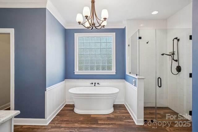 912 Silver Charm Ln, York, SC 29745 - bathroom featuring a shower stall, a freestanding bath, crown molding, wood finished floors, and a chandelier
