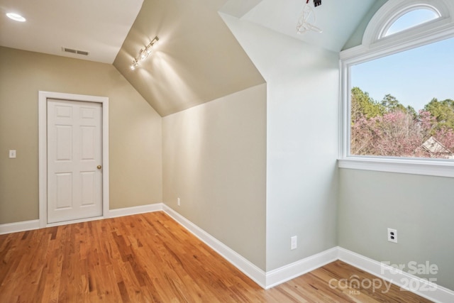 912 Silver Charm Ln, York, SC 29745 - bonus room featuring lofted ceiling, wood finished floors, and baseboards