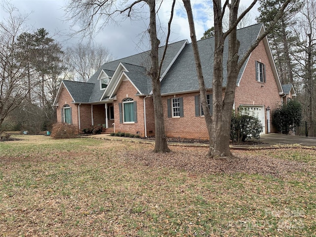 912 Silver Charm Ln, York, SC 29745 - traditional home with an attached garage, asphalt driveway, brick siding, a shingled roof, and a front lawn