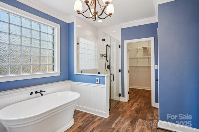 912 Silver Charm Ln, York, SC 29745 - bathroom featuring a stall shower, a spacious closet, a freestanding tub, wood finished floors, and a chandelier