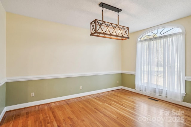 912 Silver Charm Ln, York, SC 29745 - unfurnished room with wood finished floors, a textured ceiling, and baseboards