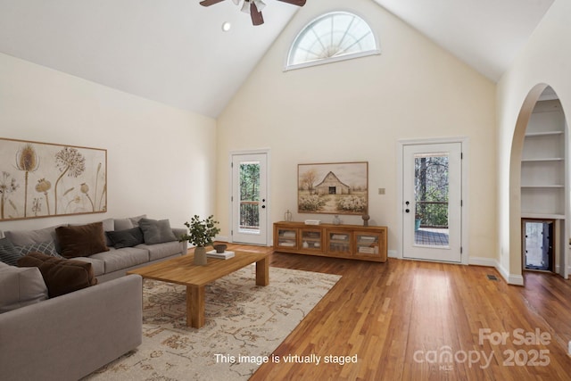 912 Silver Charm Ln, York, SC 29745 - living room featuring a ceiling fan, high vaulted ceiling, arched walkways, and plenty of natural light