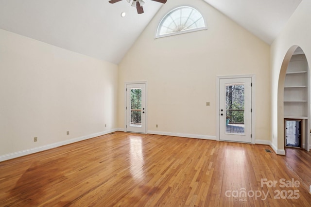912 Silver Charm Ln, York, SC 29745 - unfurnished living room with ceiling fan, high vaulted ceiling, healthy amount of natural light, arched walkways, and light wood-style floors