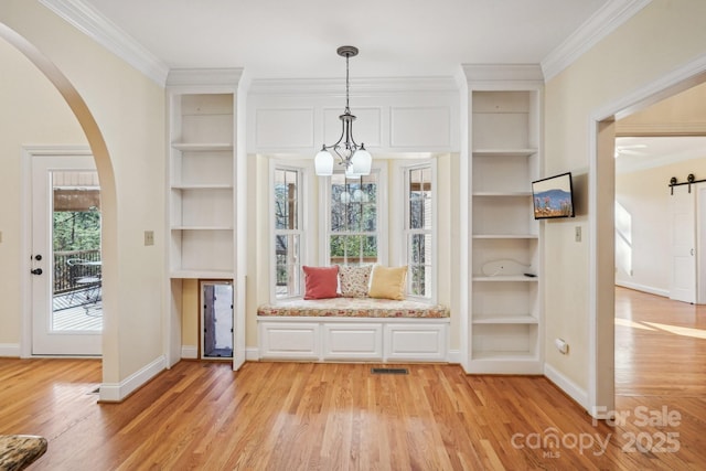 912 Silver Charm Ln, York, SC 29745 - foyer with light wood-type flooring, arched walkways, crown molding, baseboards, and a chandelier