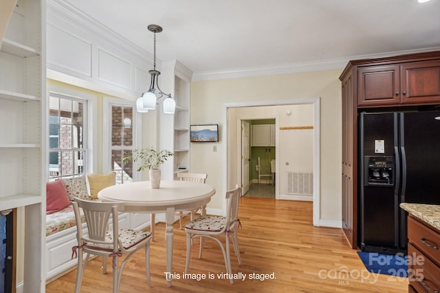 912 Silver Charm Ln, York, SC 29745 - dining area featuring crown molding, light wood-style floors, built in features, and baseboards