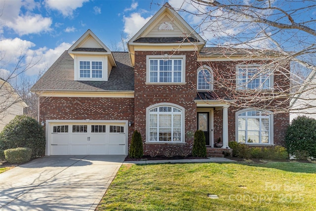 traditional home featuring driveway, brick siding, roof with shingles, and a front yard