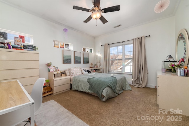 bedroom featuring light carpet, ornamental molding, visible vents, and a ceiling fan