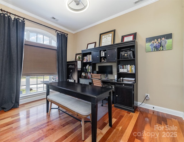 home office with crown molding, baseboards, wood finished floors, and a healthy amount of sunlight