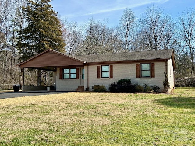 ranch-style house with a front lawn, a carport, and brick siding