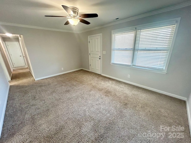 unfurnished bedroom with carpet floors, baseboards, and ornamental molding