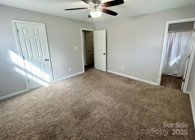 unfurnished bedroom with ceiling fan, a closet, carpet, and baseboards