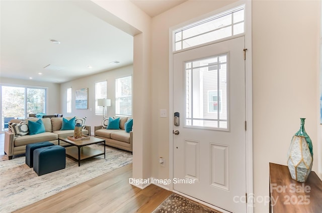 foyer entrance with light wood finished floors