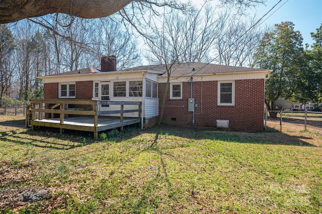 back of house featuring brick siding, fence, crawl space, a lawn, and a wooden deck