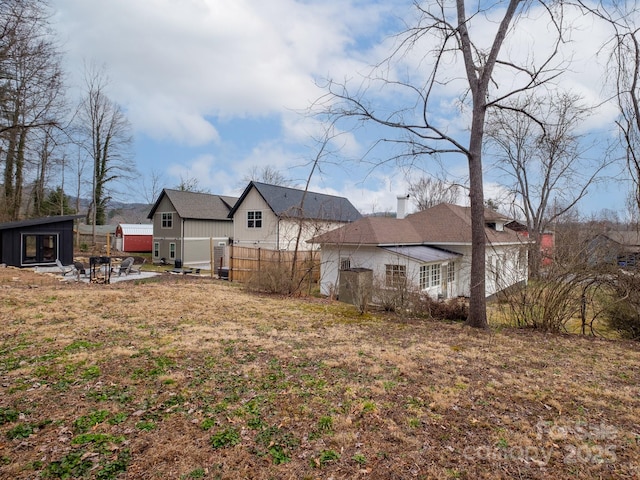 view of yard with fence and an outdoor structure