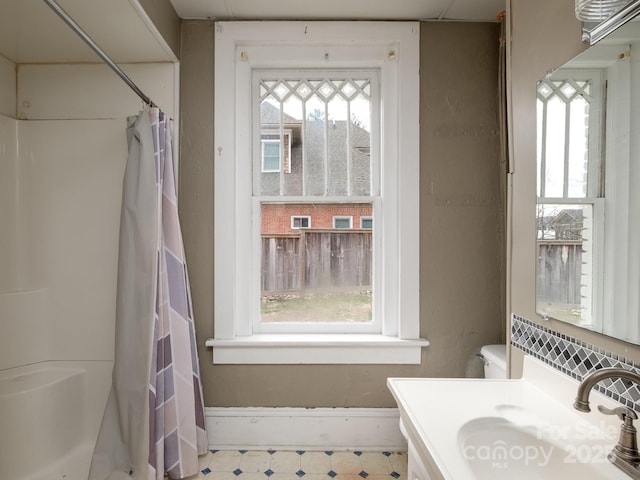 full bath featuring curtained shower, vanity, and tile patterned floors