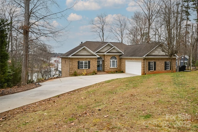 view of front of house with a garage, brick siding, driveway, and a front lawn