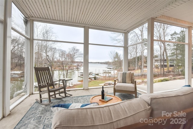 sunroom / solarium with a water view and wood ceiling