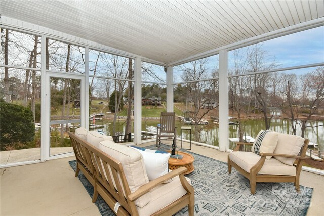 sunroom / solarium featuring a water view