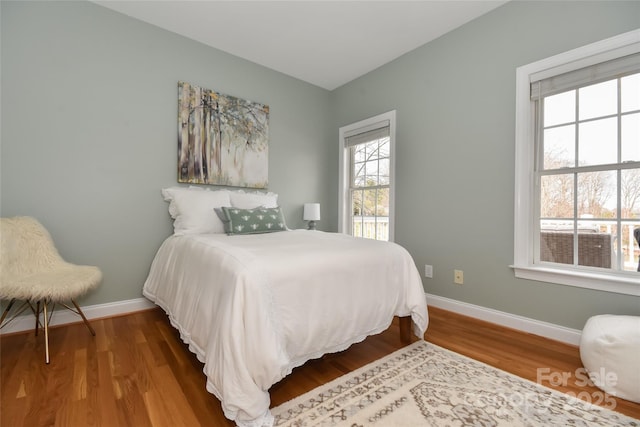 bedroom with wood finished floors and baseboards