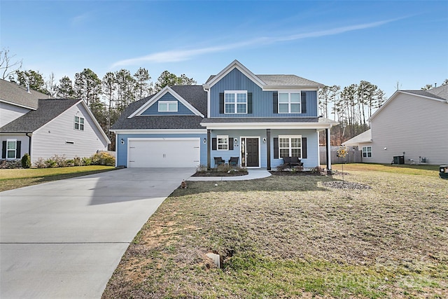 view of front of home featuring a garage, concrete driveway, central air condition unit, a porch, and a front yard