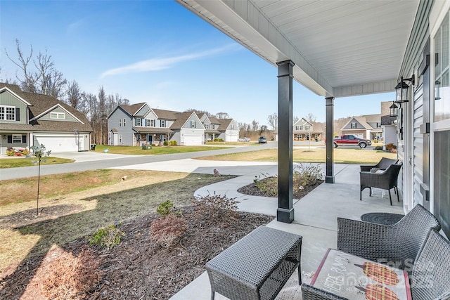 view of patio / terrace with a residential view and a porch