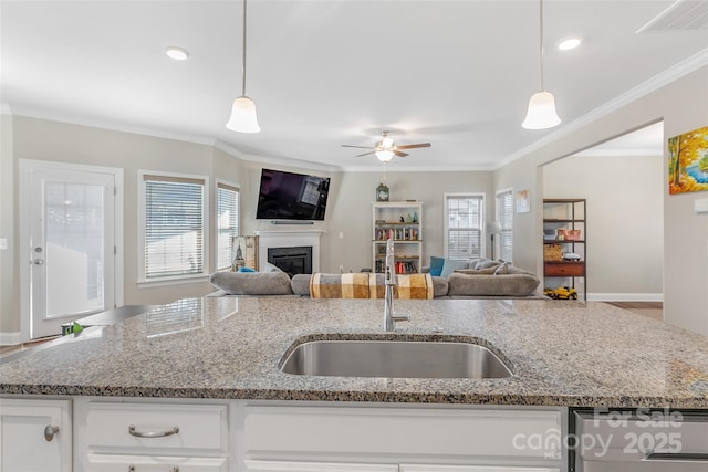 kitchen with open floor plan, white cabinetry, and pendant lighting