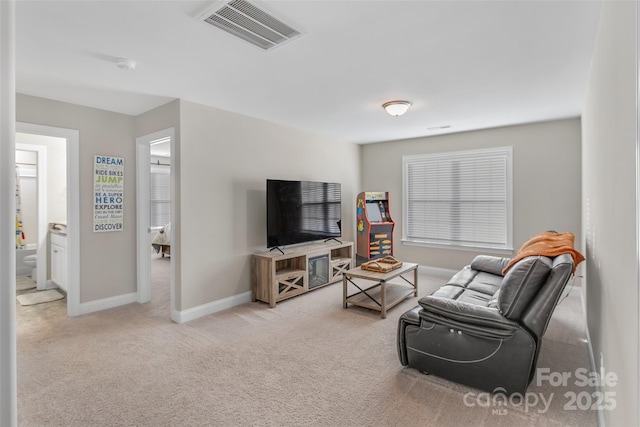 living room featuring light colored carpet, visible vents, and baseboards