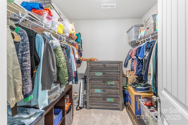 walk in closet with light carpet and visible vents