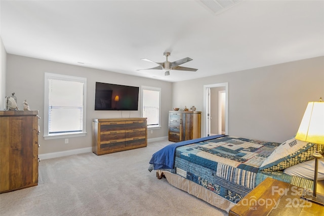 bedroom with a ceiling fan, carpet flooring, visible vents, and baseboards