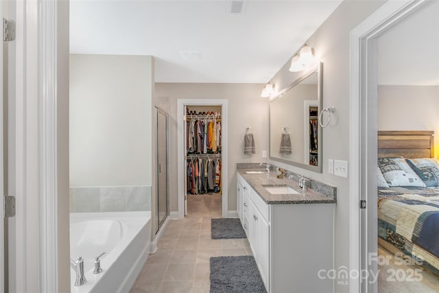 bathroom featuring double vanity, a sink, visible vents, and tile patterned floors