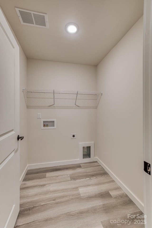 washroom featuring hookup for an electric dryer, laundry area, washer hookup, visible vents, and light wood finished floors