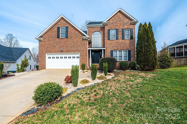 traditional-style home featuring driveway, an attached garage, a front lawn, and brick siding