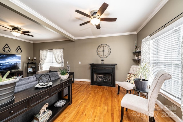 interior space featuring ornamental molding, a fireplace, light wood-style flooring, and baseboards