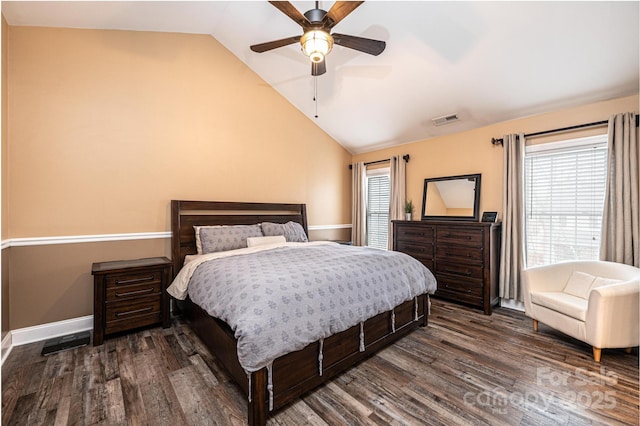 bedroom featuring multiple windows, visible vents, vaulted ceiling, and dark wood-style flooring