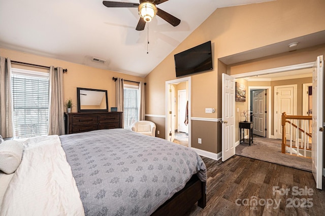 bedroom with dark wood-style flooring, lofted ceiling, visible vents, a ceiling fan, and baseboards