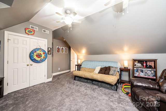 interior space featuring a ceiling fan, visible vents, vaulted ceiling, and carpet flooring