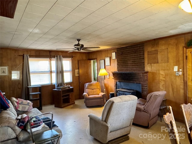 living area featuring a fireplace, wood walls, and ceiling fan