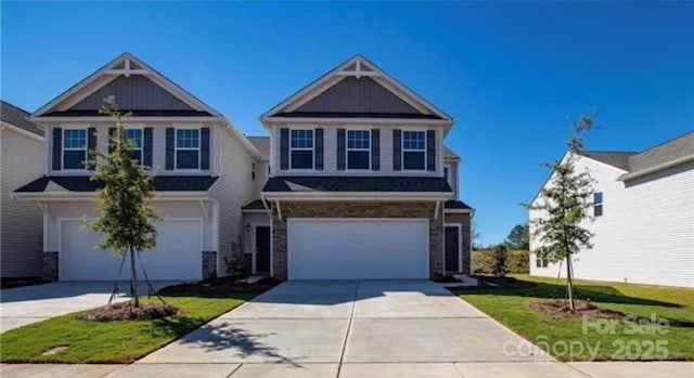 view of front of property featuring a garage, driveway, and a front lawn