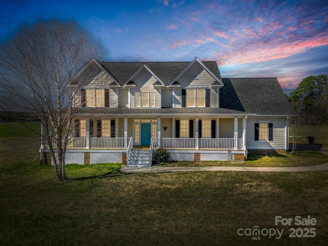 view of front of property featuring a porch, roof with shingles, and a yard