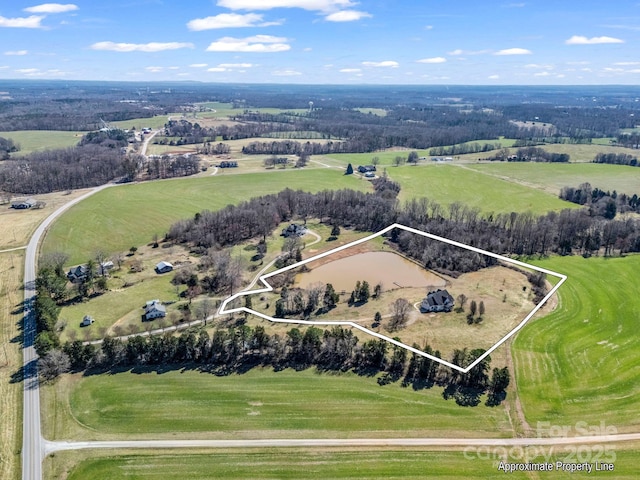 birds eye view of property featuring a rural view