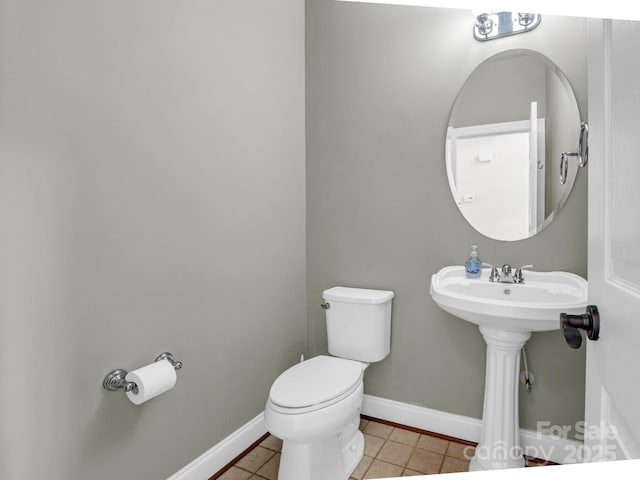 bathroom featuring baseboards, toilet, and tile patterned floors