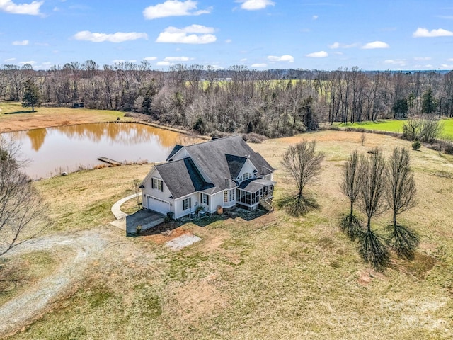 birds eye view of property featuring a water view and a view of trees