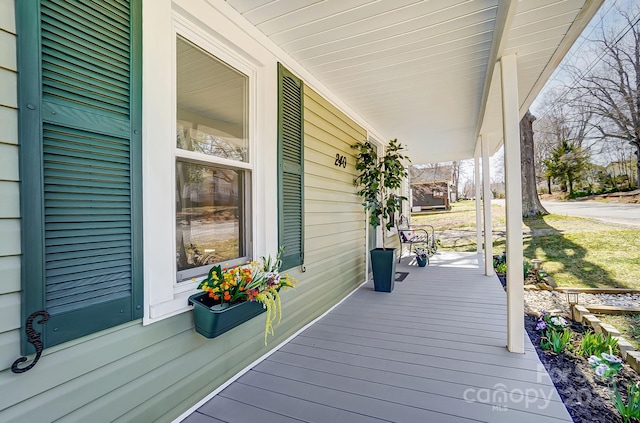 wooden terrace featuring a porch