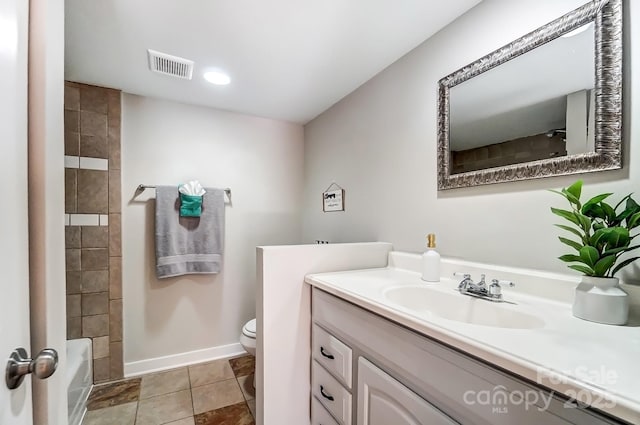 bathroom featuring visible vents, baseboards, toilet, tile patterned floors, and vanity